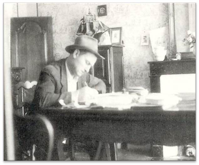 Pierre Doux signing documents in his office